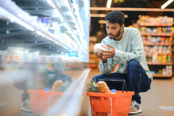 Portrait of indian man purchasing in a grocery store. Buying grocery for home in a supermarket.