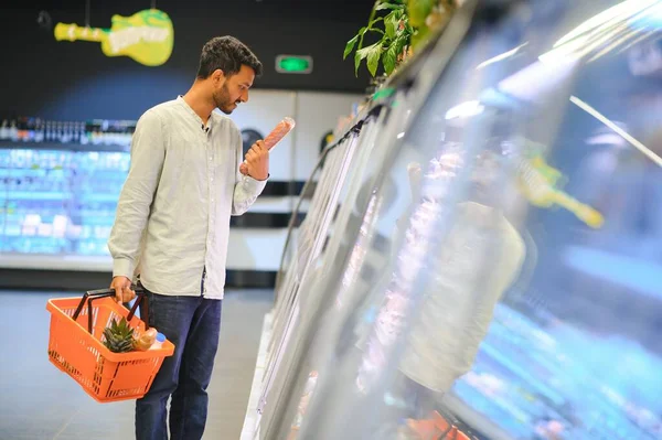 Portrait of indian man purchasing in a grocery store. Buying grocery for home in a supermarket.