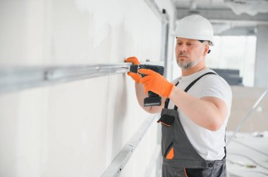 Alçıpan bölmesi için metal profil çerçevesini duvara bağlayın.