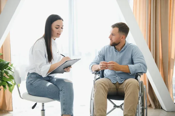 stock image Portrait of female psychiatrist interviewing handicapped man during therapy session, copy space