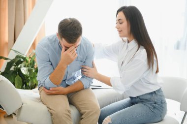 female psychologist making note while patient talking.