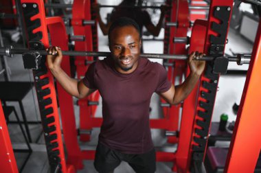 Spor salonunda çalışan yakışıklı, Afro-Amerikan bir adam..