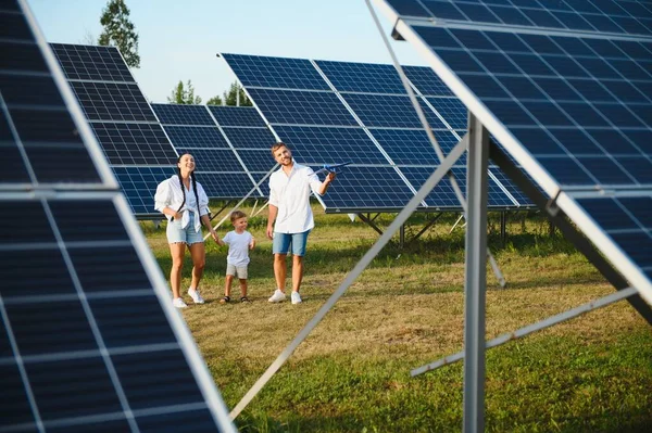 Happy young family near solar panels. Solar energy