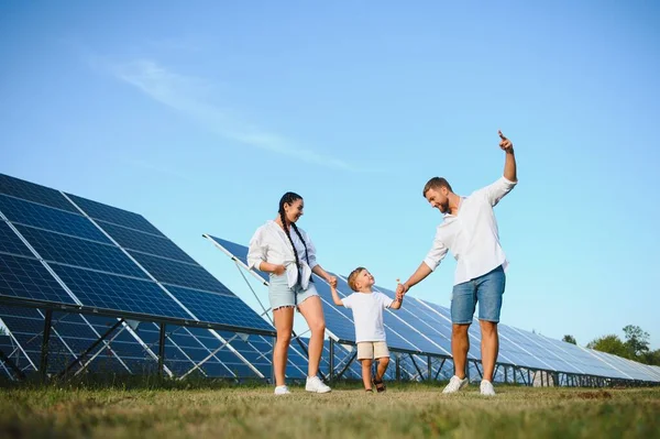Happy young family near solar panels. Solar energy