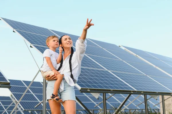 stock image Mother with her little son by solar panels.