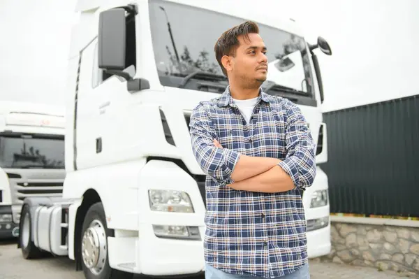 Portrait of confident indian truck driver on parking. Copy space.