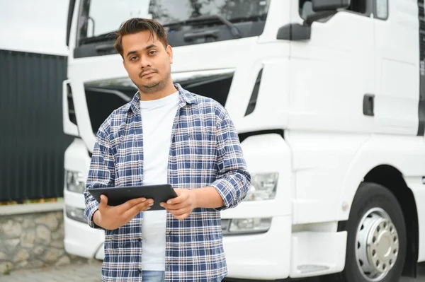 Young indian businessman with his freight forward lorry or truck