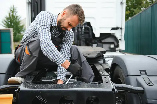 Male Mechanic repairing the truck.