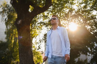 sopa tutan kaldırımda yürüyen kör adam