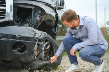 Man wait for insurance call center to help after a car crash accident on the road.