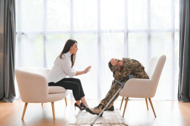 Psikolog üzgün erkek asker, Ptsd ile terapi oturumu sırasında notlar yapma.