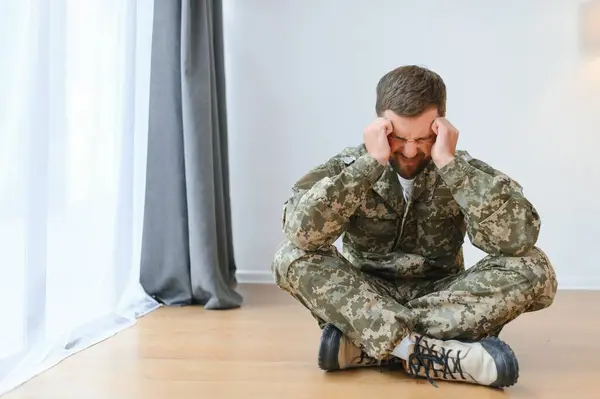 Depressed man recalling war days. Portrait of veteran soldier who has PTSD.