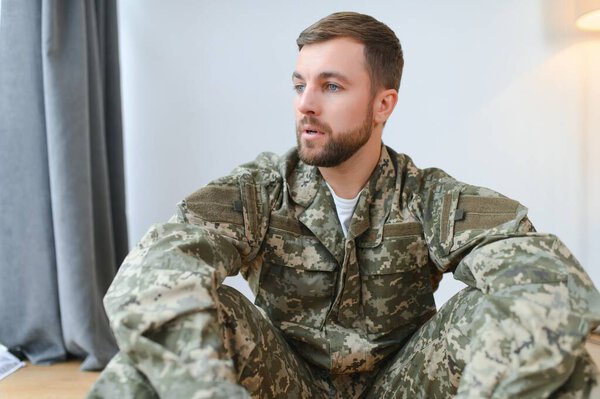 Depressed man recalling war days. Portrait of veteran soldier who has PTSD.