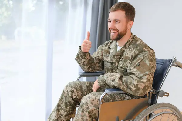 Unhappy military man sitting in wheelchair
