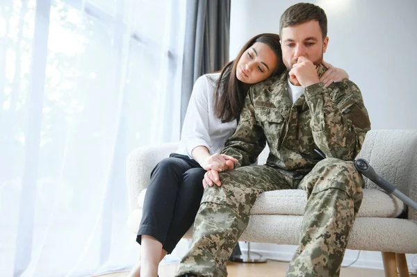 A wife supports a sad military husband who has health problems after returning home from the war.