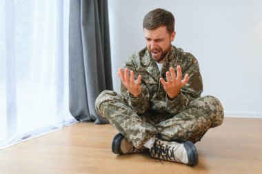 Travma sonrası stres bozukluğu olan eski bir asker evde bağırıyor..