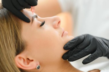 Kaş dövmesi ya da kalıcı makyaj. Güzel bir kadının ayrıntıları, Güzellik Salonunda güzel siyah kaşları olan bir kaş. Güzellik kaşı güncelleme prosedürü.