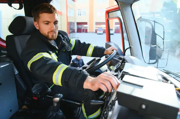 Firefighter using radio set while driving fire truck.