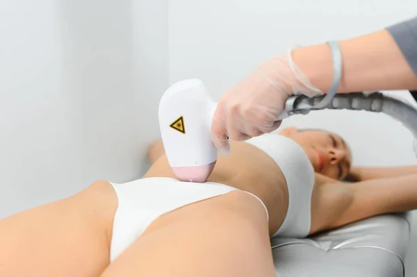 laser hair removal. Woman on laser hair removal treatments thighs and bikini area.
