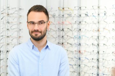 Adam görüş düzeltmesi için göz doktorunda gözlük seçiyor. Görüş düzeltmesi için gözlük.