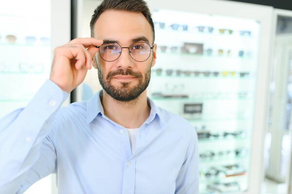 man chooses glasses for vision correction in an ophthalmology salon. Glasses for vision correction.