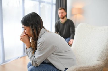 Tedirgin ve üzgün bir koca bağırır ve karısına bakar, eşler arasında bir kavga. Aile anlaşmazlığı, kavga..