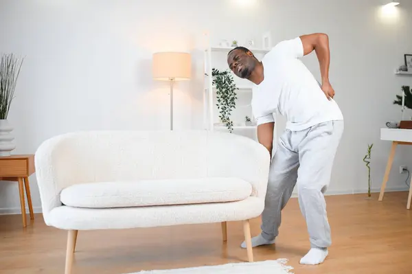 Young African Man Having Back Pain.