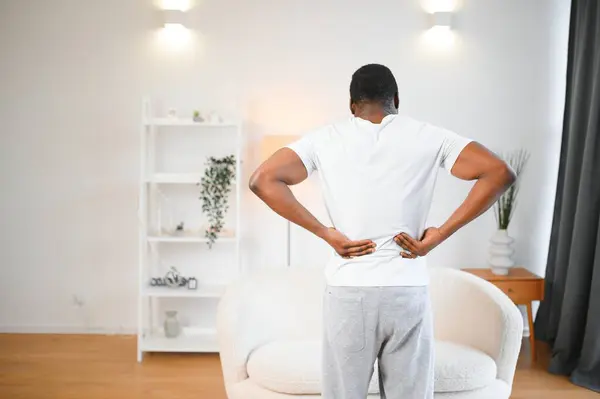 Young African Man Having Back Pain.