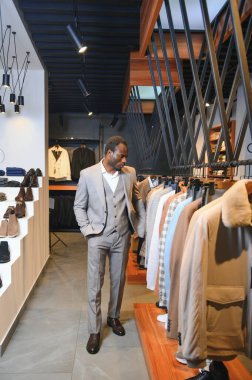 Yakışıklı bir Afrikalı beyefendi zarif bir takım elbise alıyor..