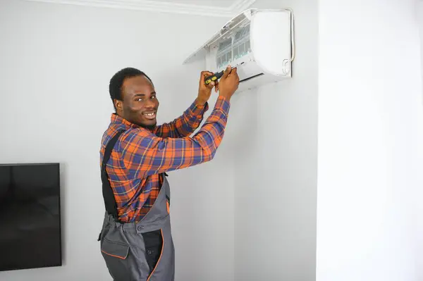 AC Electrician Technician Repairing Air Conditioner Appliance.