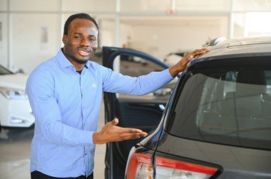 Mutlu Araba Alıcısı, Yeni Araba Sahibi Konsepti. Galerideki heyecanlı Afrikalı Amerikalı adamın portresi..