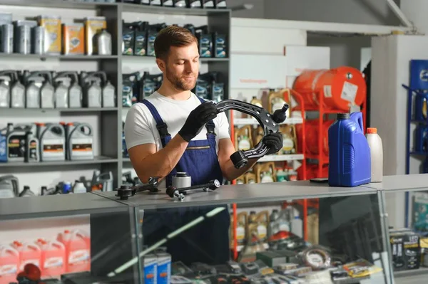 Auto parts store. The seller receives the product and evaluates the quality.