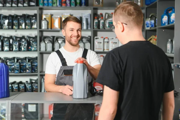 A customer speaks with a consultant at an auto parts store.