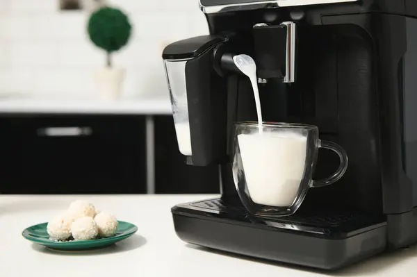 Home professional coffee machine with cappuccino cup. coffee machine latte macchiato cappuccino milk foam prepare concept.