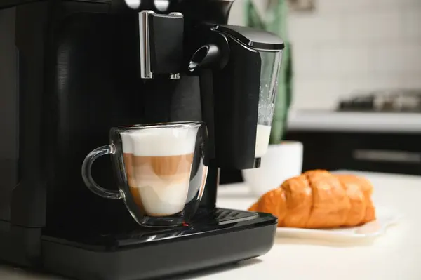 Home professional coffee machine with cappuccino cup. coffee machine latte macchiato cappuccino milk foam prepare concept.