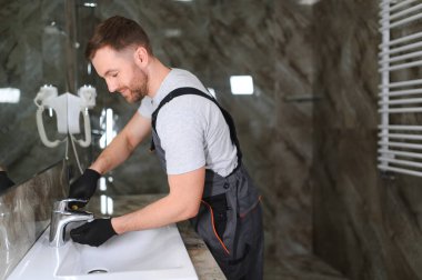 Tesisatçı bir lavabo musluk tamiri.