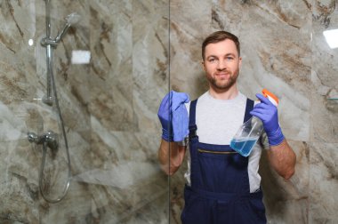 Temizlik hizmet anlayışı. Banyo dolabında cam temizleme adam.