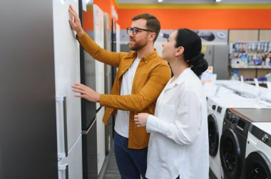 Genç çift yeni buzdolabı seçiyor..