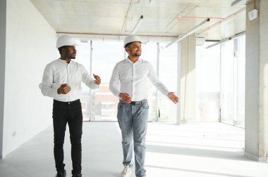 Hintli ve Afrikalı Amerikalı mühendisler inşaat alanında.
