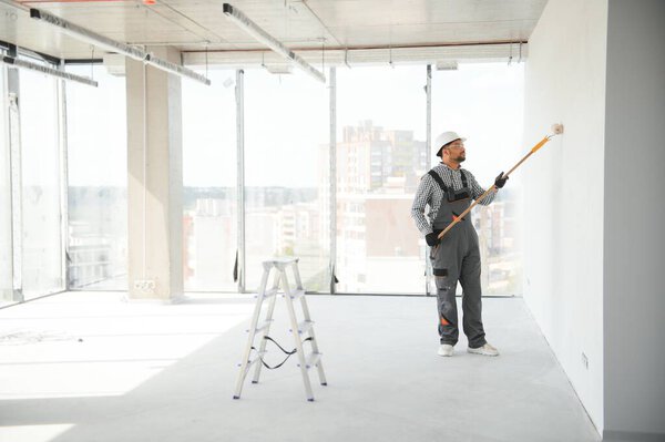 Indian Apartment Repair Worker Paints White Wall Roller Royalty Free Stock Images