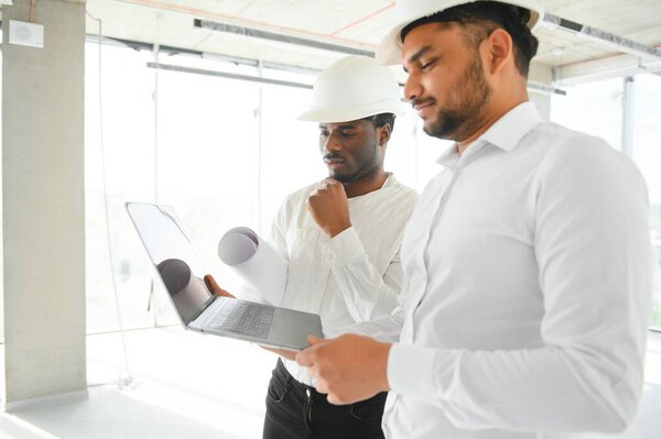 Engineers Team Discussing While Inspecting Construction Site Stock Picture