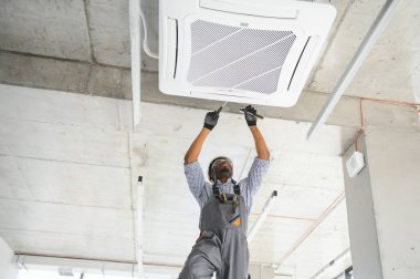 Mutlu genç Afrika erkek teknisyen Klima tamiri.