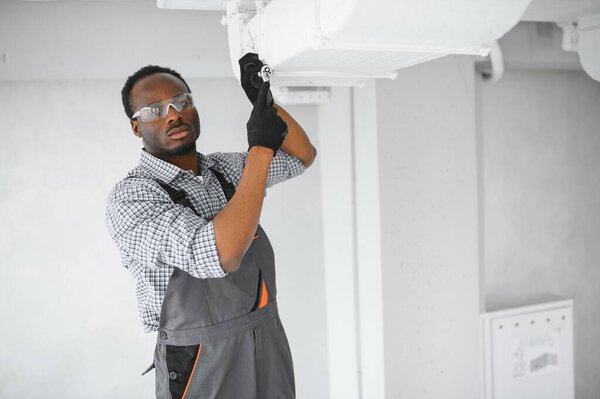 Industrial Theme Warehouse Heating Cooling System Installation Professional Caucasian Technician Royalty Free Stock Images