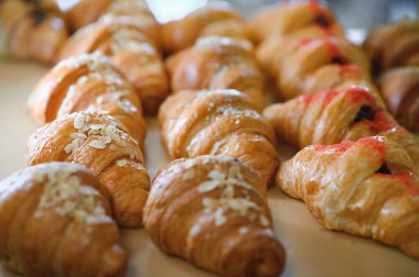 Fırında kruvasan. Pasta dükkanında hamur işi pişirmek. Fransız kruvasanları yaklaş..
