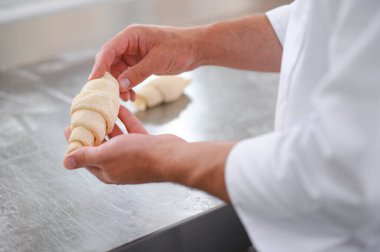 Pasta şefi fırında kruvasan yapıyor..