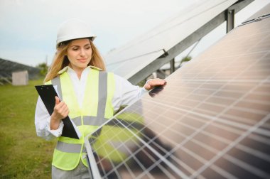 Pano konumu güneş panelleri açık havada yakın olan güzel genç mühendis.