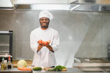 Afro-Amerikalı aşçı restoran mutfağında mutfak tezgahında duruyor..