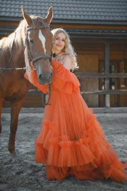 young woman in a dress with a horse.