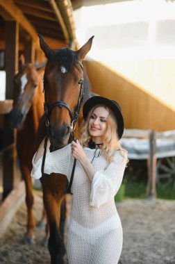 young woman in a dress with a horse.