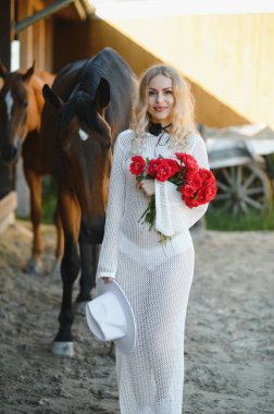 young woman in a dress with a horse.